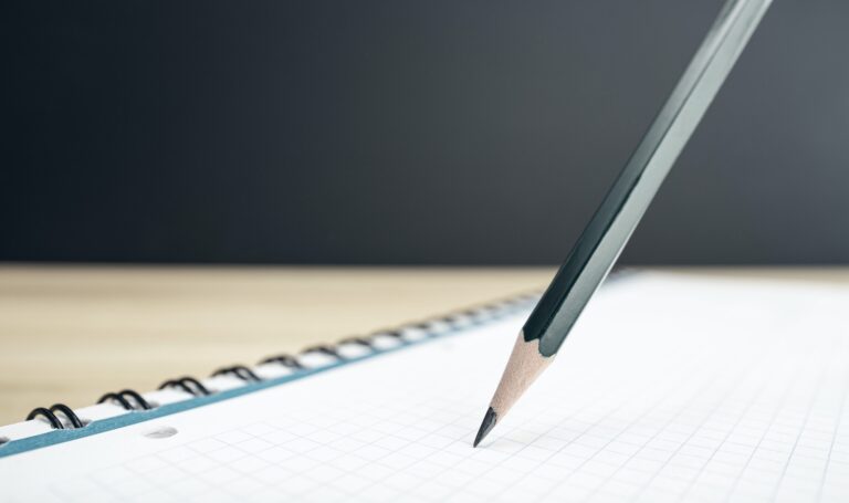 Close up of a Pencil and blank notebook