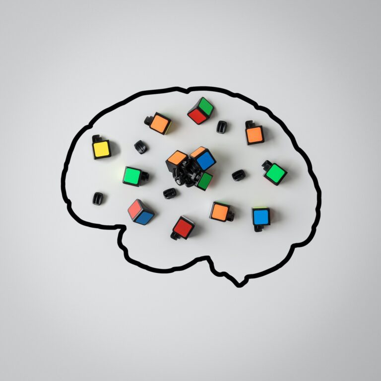 Concept of mental health. Silhouette of a human brain with a broken puzzle on a gray background.