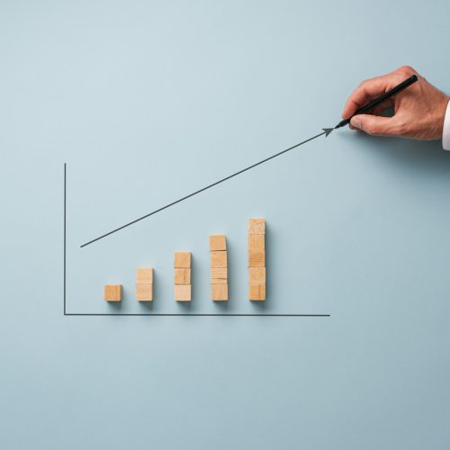 Businessman drawing financial graph